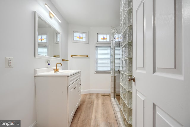 4108 Slater Ave, Baltimore, MD 21236 - bathroom featuring vanity, a shower, wood finished floors, and baseboards