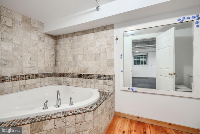 4108 Slater Ave, Baltimore, MD 21236 - full bathroom with a garden tub, wood finished floors, toilet, and baseboards
