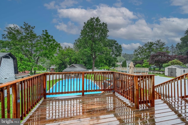 4108 Slater Ave, Baltimore, MD 21236 - deck featuring an outdoor pool and view of wooded area