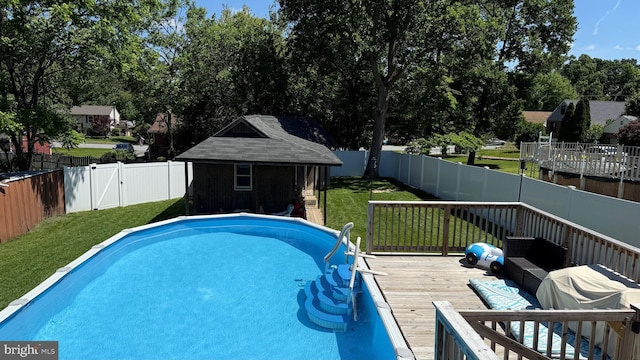 4108 Slater Ave, Baltimore, MD 21236 - view of swimming pool featuring a deck, an outdoor structure, and view of wooded area