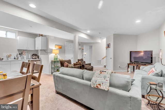 10079 Orland Stone Dr, Bristow, VA 20136 - living area featuring baseboards, recessed lighting, and light colored carpet
