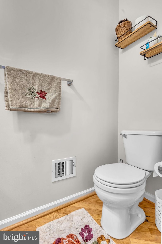 10079 Orland Stone Dr, Bristow, VA 20136 - bathroom featuring baseboards, toilet, and wood finished floors