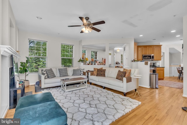 10079 Orland Stone Dr, Bristow, VA 20136 - living room with light wood finished floors, ceiling fan, recessed lighting, and baseboards