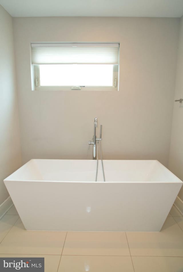 708 N 17th St, Philadelphia, PA 19130 - bathroom featuring plenty of natural light, a freestanding tub, and tile patterned flooring