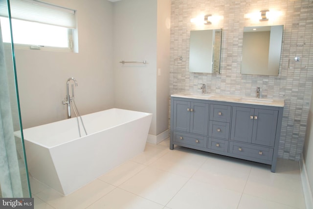 708 N 17th St, Philadelphia, PA 19130 - full bathroom featuring a soaking tub, double vanity, tile patterned floors, and decorative backsplash