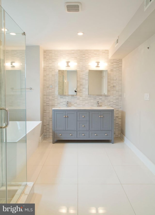 708 N 17th St, Philadelphia, PA 19130 - full bathroom with tile patterned flooring, double vanity, a stall shower, baseboards, and a freestanding bath