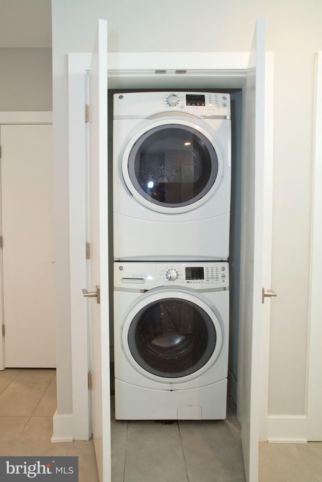 708 N 17th St, Philadelphia, PA 19130 - washroom with estacked washer and dryer, light tile patterned flooring, and baseboards