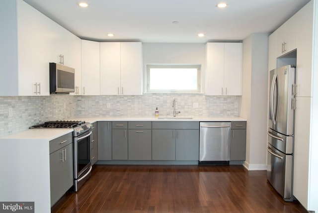 708 N 17th St, Philadelphia, PA 19130 - kitchen featuring appliances with stainless steel finishes, a sink, gray cabinets, dark wood-style floors, and recessed lighting