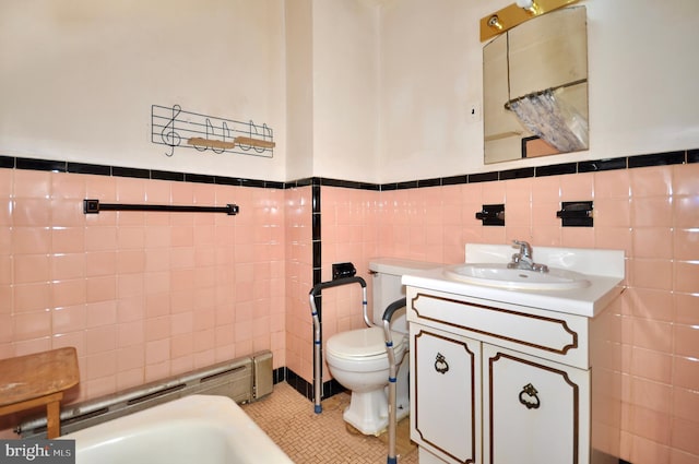 3324 Ryan Ave, Philadelphia, PA 19136 - bathroom featuring tile walls, toilet, vanity, a wainscoted wall, and a bath