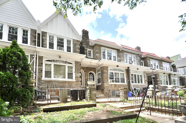 3324 Ryan Ave, Philadelphia, PA 19136 - view of front of property with stone siding, a garden, board and batten siding, and a chimney