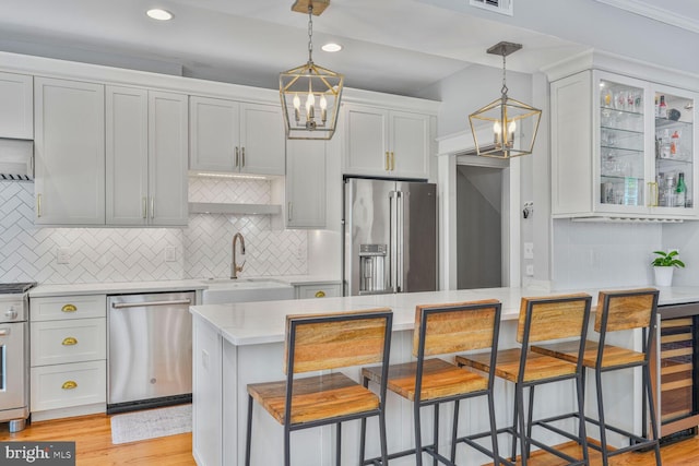 3805 Warren St NW, Washington, DC 20016 - kitchen featuring stainless steel appliances, a sink, a chandelier, light countertops, and recessed lighting