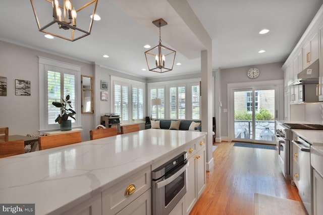 3805 Warren St NW, Washington, DC 20016 - kitchen featuring a chandelier, under cabinet range hood, stainless steel appliances, recessed lighting, and white cabinetry