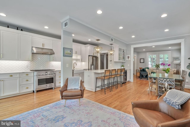 3805 Warren St NW, Washington, DC 20016 - living area with crown molding, light wood-style floors, and recessed lighting