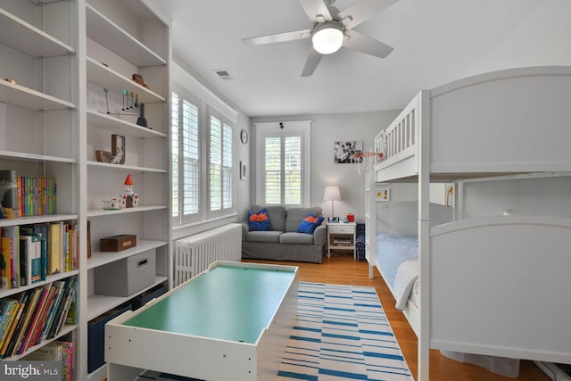 3805 Warren St NW, Washington, DC 20016 - bedroom featuring radiator heating unit, light wood-style floors, and ceiling fan