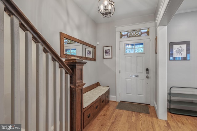 3805 Warren St NW, Washington, DC 20016 - entryway with stairs, light wood-style floors, baseboards, a chandelier, and ornamental molding
