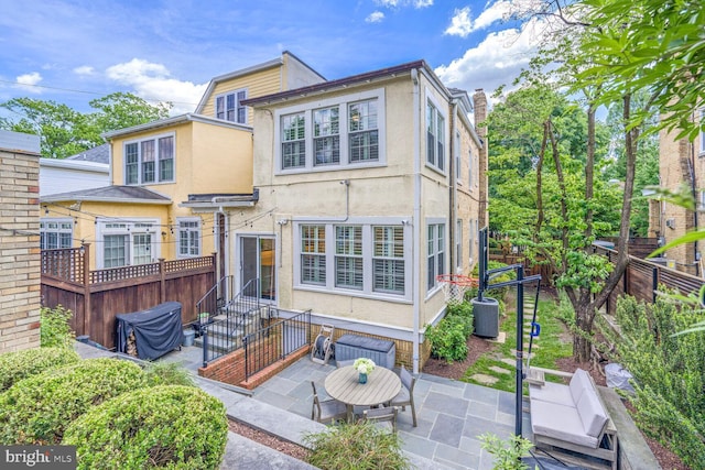 3805 Warren St NW, Washington, DC 20016 - rear view of property with stucco siding, a patio, entry steps, and a chimney