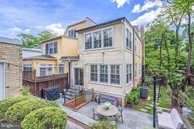3805 Warren St NW, Washington, DC 20016 - rear view of property featuring stucco siding, a patio, cooling unit, and entry steps
