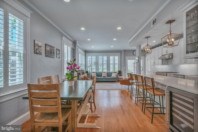 3805 Warren St NW, Washington, DC 20016 - dining area featuring wine cooler, ornamental molding, healthy amount of natural light, recessed lighting, and light wood finished floors