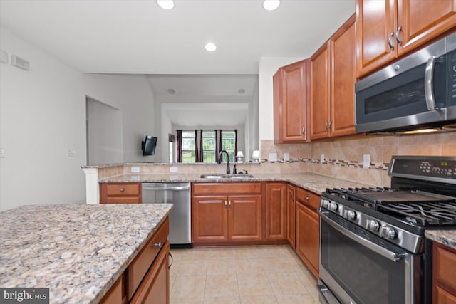133 E General Grey Ct, Newark, DE 19702 - kitchen with stainless steel appliances, a sink, tasteful backsplash, light stone countertops, and recessed lighting