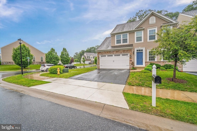 133 E General Grey Ct, Newark, DE 19702 - view of front of house featuring stone siding, asphalt driveway, a garage, and a front yard