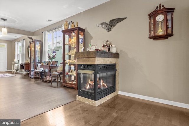 220 Wilshire Blvd, Woolwich Twp, NJ 08085 - living room featuring wood finished floors, a multi sided fireplace, and baseboards