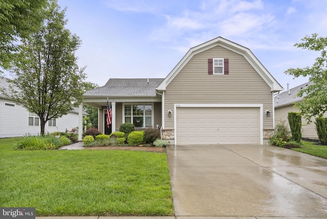 220 Wilshire Blvd, Woolwich Twp, NJ 08085 - view of front of house with concrete driveway, a front yard, stone siding, an attached garage, and a shingled roof