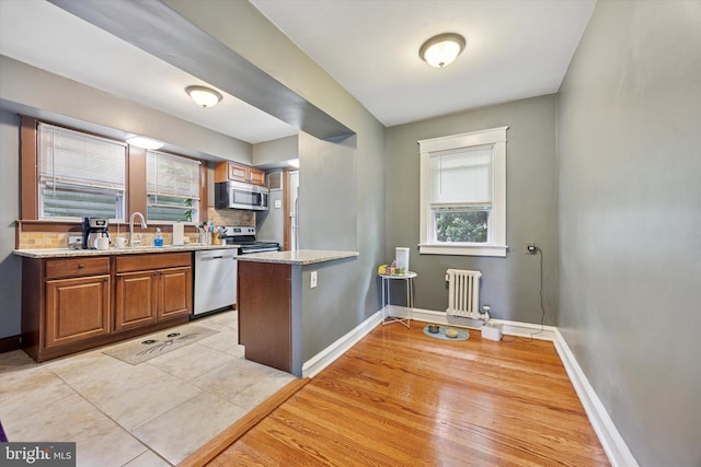 904 Alexander Ave, Drexel Hill, PA 19026 - kitchen featuring appliances with stainless steel finishes, radiator heating unit, healthy amount of natural light, and baseboards