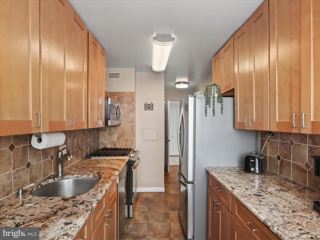 301 N Beauregard St Unit 905, Alexandria, VA 22312 - kitchen featuring appliances with stainless steel finishes, a sink, decorative backsplash, and light stone counters