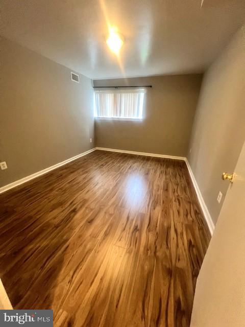 8485 Greenbelt Rd Unit 8485-T-1, Greenbelt, MD 20770 - empty room with dark wood finished floors and baseboards