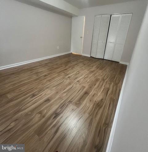 8485 Greenbelt Rd Unit 8485-T-1, Greenbelt, MD 20770 - unfurnished bedroom featuring wood finished floors, a closet, and baseboards
