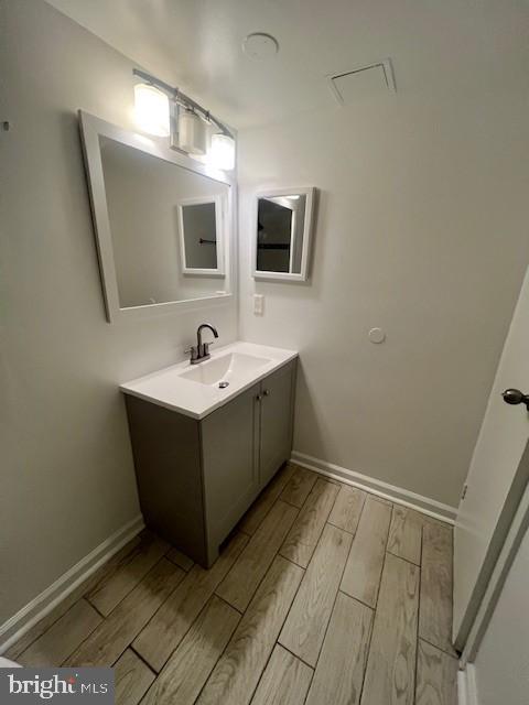 8485 Greenbelt Rd Unit 8485-T-1, Greenbelt, MD 20770 - bathroom with wood finish floors, vanity, and baseboards