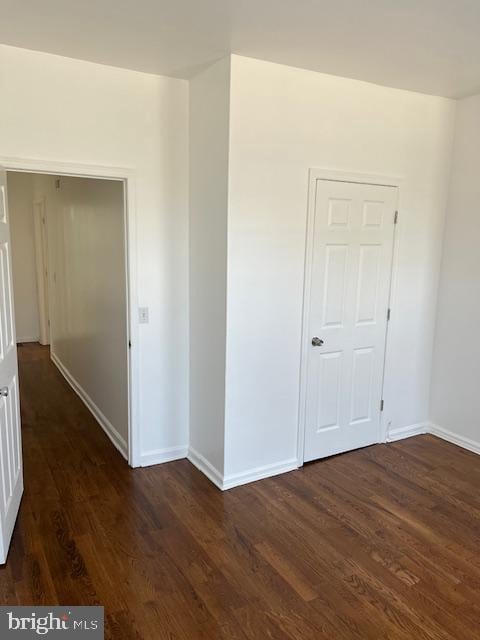 1910 Mcclellan St, Philadelphia, PA 19145 - empty room featuring baseboards and dark wood-type flooring