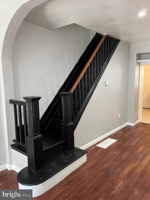 1910 Mcclellan St, Philadelphia, PA 19145 - stairs featuring arched walkways, baseboards, wood finished floors, and recessed lighting