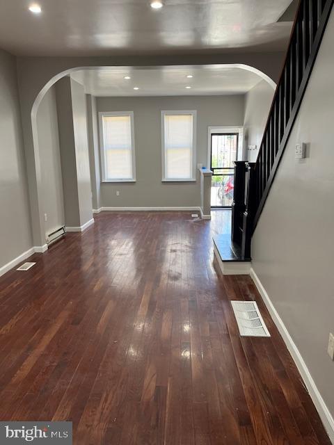 1910 Mcclellan St, Philadelphia, PA 19145 - entrance foyer featuring arched walkways, a baseboard heating unit, dark wood-style floors, baseboards, and recessed lighting