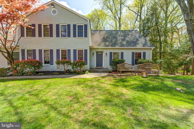 12209 Lake James Dr, Herndon, VA 20171 - view of front of house with a front yard, a shingled roof, and brick siding