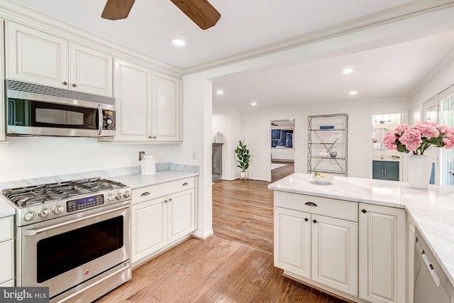 12209 Lake James Dr, Herndon, VA 20171 - kitchen featuring stainless steel appliances, ceiling fan, light wood finished floors, light stone countertops, and white cabinetry