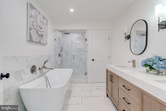 12209 Lake James Dr, Herndon, VA 20171 - bathroom featuring a shower stall, a soaking tub, marble finish floors, double vanity, and recessed lighting