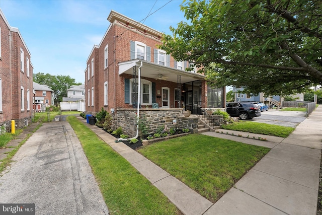 16 W Langhorne Ave, Havertown, PA 19083 - view of property with brick siding, a front lawn, a ceiling fan, covered porch, and driveway