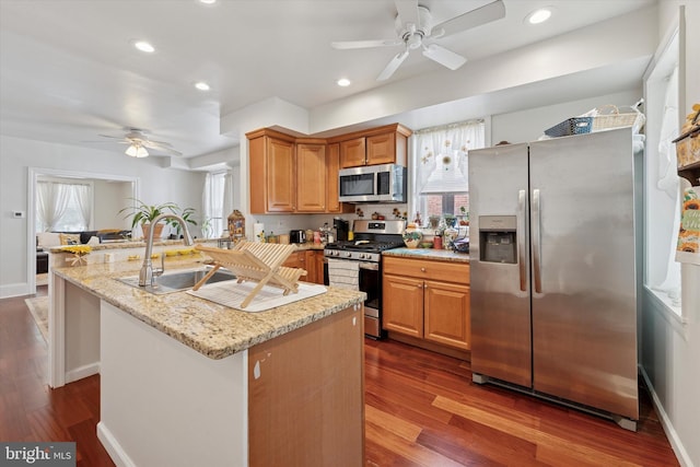 16 W Langhorne Ave, Havertown, PA 19083 - kitchen with stainless steel appliances, a ceiling fan, a sink, dark wood-style floors, and a peninsula