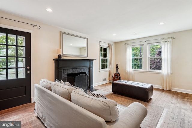 2106 Ross Rd, Silver Spring, MD 20910 - living room with healthy amount of natural light, a high end fireplace, wood finished floors, and recessed lighting