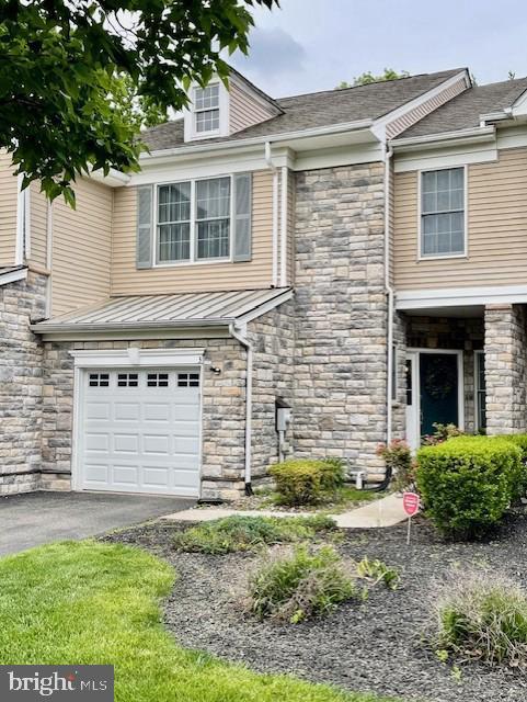 3 Wedgewood Ct, Princeton, NJ 08540 - view of front facade with stone siding, an attached garage, and driveway