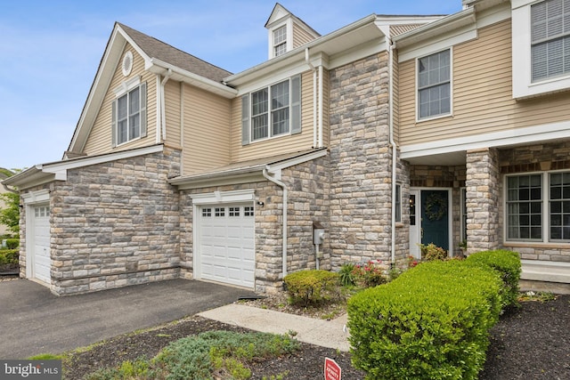 3 Wedgewood Ct, Princeton, NJ 08540 - view of property featuring stone siding, an attached garage, and driveway