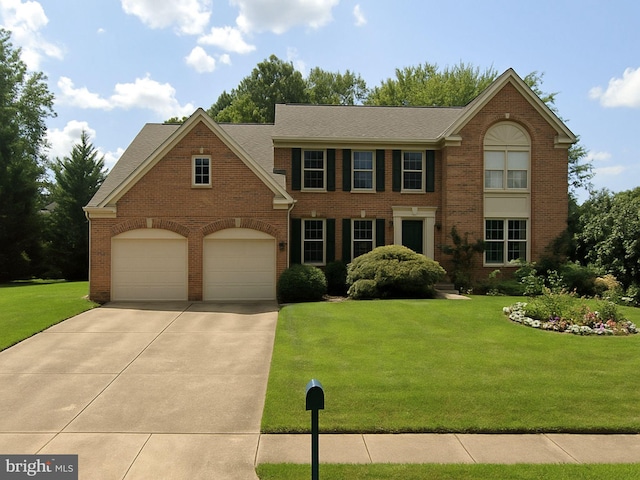 3663 Thomasson Crossing Dr, Triangle, VA 22172 - view of front of house featuring brick siding, concrete driveway, a garage, and a front yard