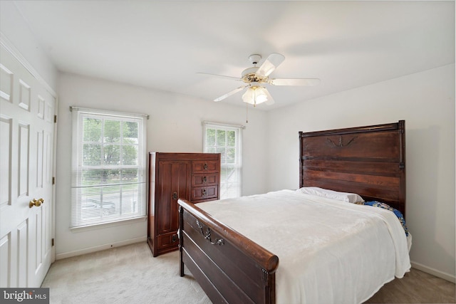 3663 Thomasson Crossing Dr, Triangle, VA 22172 - bedroom featuring multiple windows, light colored carpet, and a ceiling fan
