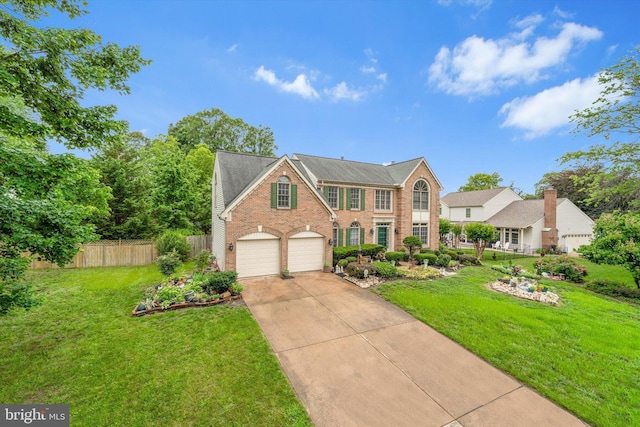 3663 Thomasson Crossing Dr, Triangle, VA 22172 - view of front of home with brick siding, driveway, and a garage
