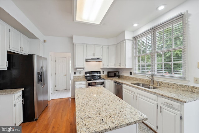 3663 Thomasson Crossing Dr, Triangle, VA 22172 - kitchen featuring appliances with stainless steel finishes, white cabinets, light wood-style floors, under cabinet range hood, and recessed lighting