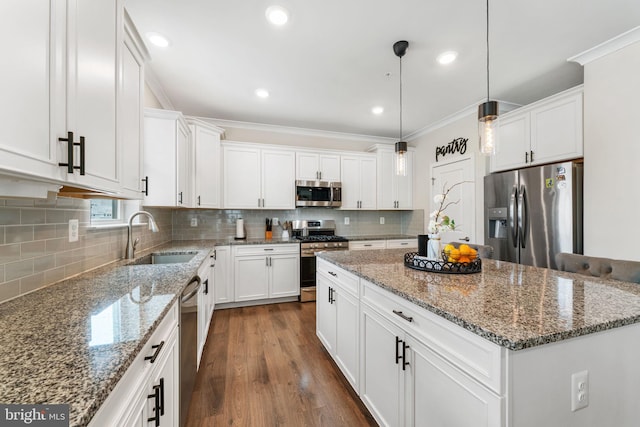 4495 Shakespeare Cir, White Plains, MD 20695 - kitchen with stainless steel appliances, ornamental molding, a center island, backsplash, and white cabinetry