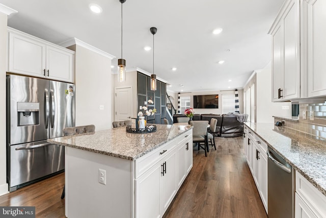 4495 Shakespeare Cir, White Plains, MD 20695 - kitchen with appliances with stainless steel finishes, white cabinets, dark wood-style floors, a center island, and open floor plan