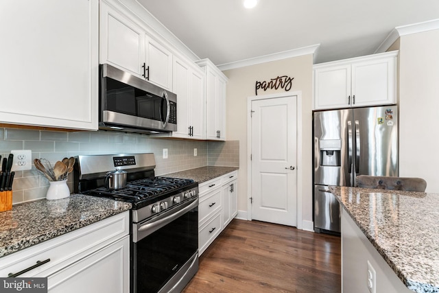 4495 Shakespeare Cir, White Plains, MD 20695 - kitchen with appliances with stainless steel finishes, ornamental molding, stone counters, white cabinets, and decorative backsplash
