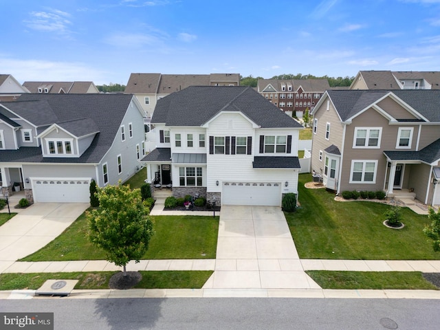 4495 Shakespeare Cir, White Plains, MD 20695 - view of front of home featuring a garage, driveway, a residential view, stone siding, and a front lawn